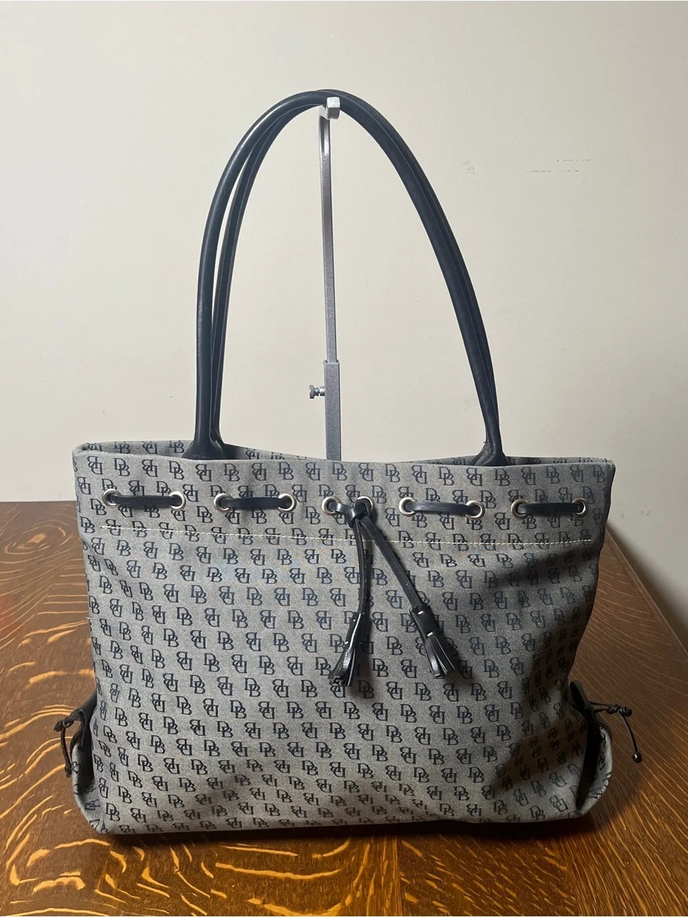 Dooney & Bourke Vintage Gray Canvas Monogram Tote with Black Trim and Tassel.